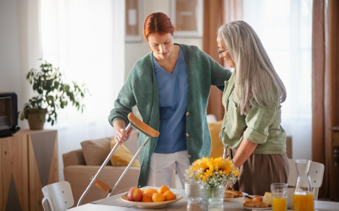 Nurse helping senior woman with walking after leg injury.