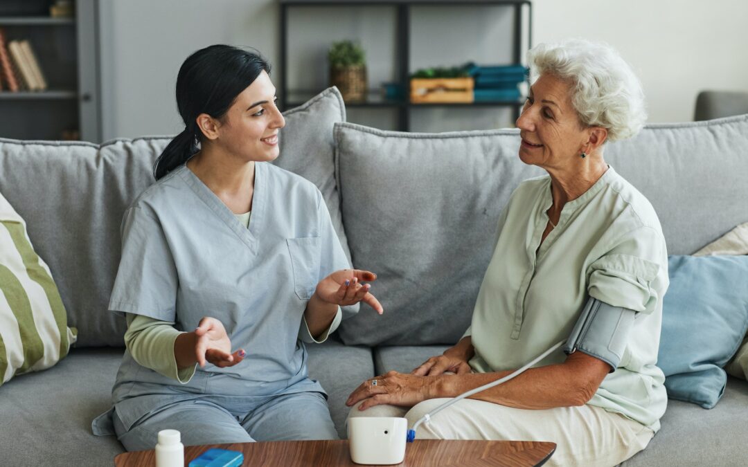 Young Nurse Talking to Senior Woman in Retirement Home