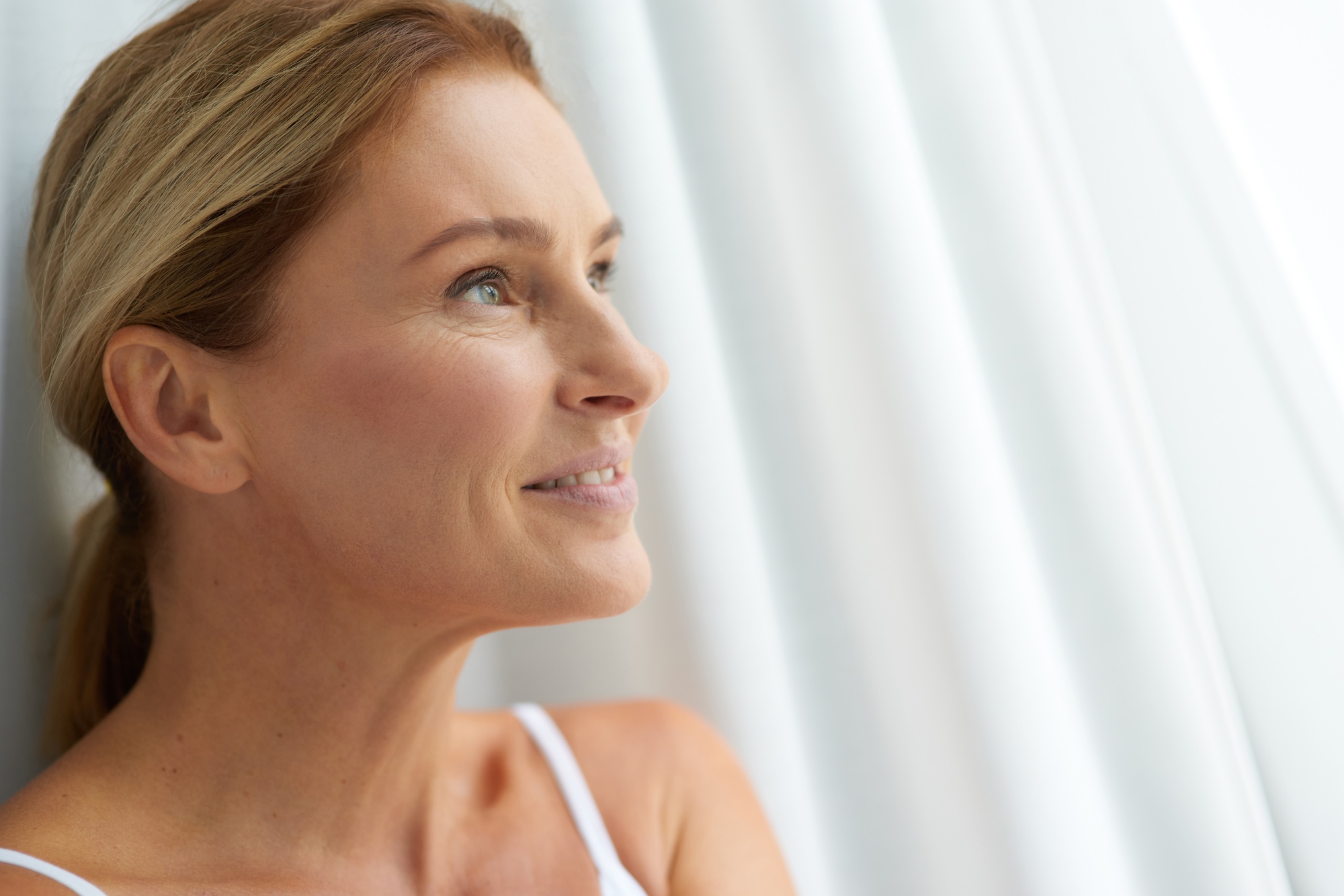Smiling mature Caucasian lady with healthy hair and skin